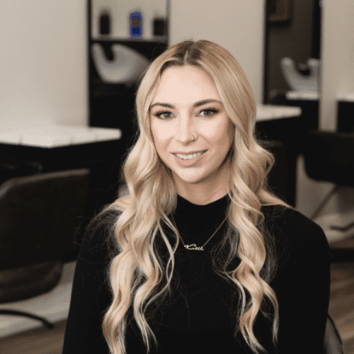 Portrait of Nikki, a professional stylist at The Cut Salon, showcasing their expertise and style.